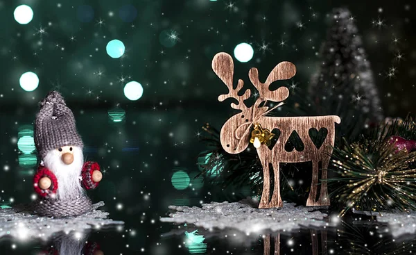 Wooden Christmas toy, a deer, on a dark, snowy background — Stock Photo, Image