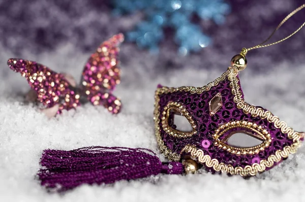 Purple carnival mask in the snow — Stock Photo, Image