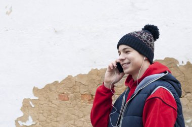 eski duvar arka plan üzerinde telefon ile genç adam