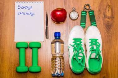 Egzersiz ve fitness diyet alanı günlüğü kopyalayın. Sağlıklı yaşam konsepti. Halter, su, genişletici el topu rustik ahşap tablo.