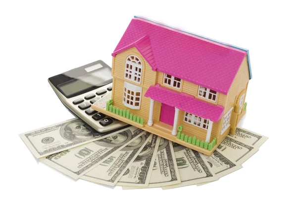 Home on a calculator and dollars — Stock Photo, Image