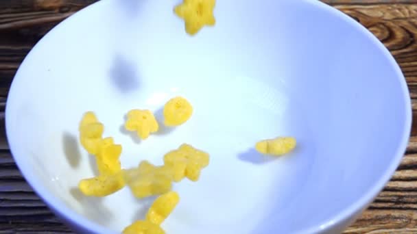 Corn breakfast cereals falling in a bowl, slow motion — Stock Video