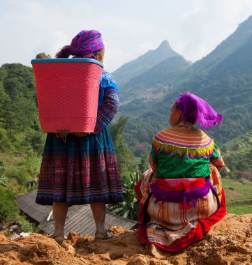 Women standing on a mountain pass clipart