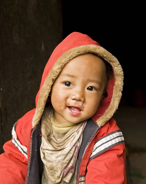 Hmong child playing in wooden house Stock Photo