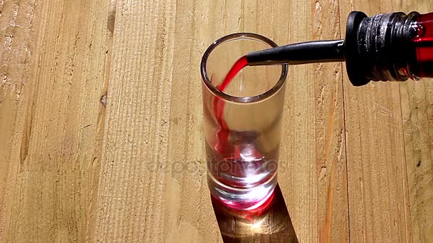 Pouring liquor into a glass — Stock Video