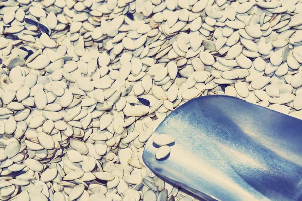 Background of the pumpkin seeds on the counter in the store.