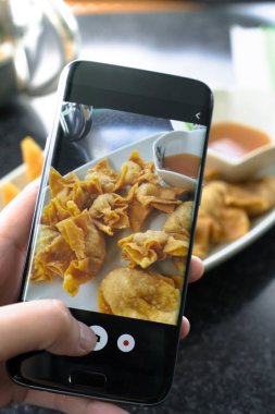 Smartphone cep telefonu ile fotoğraf res içinde Çin yemeği basarak parmak
