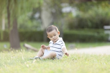 Çayır üzerinde oynarken mutlu Çinli bebek çocuk