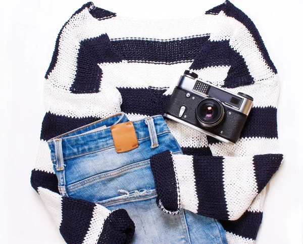 Sweater in white and blue stripes, jeans, and a camera — Stock Photo, Image