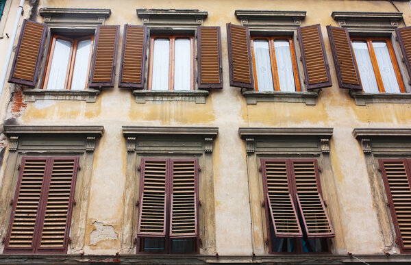 Old house with brown shutters in Florence, Italy (Firenze)