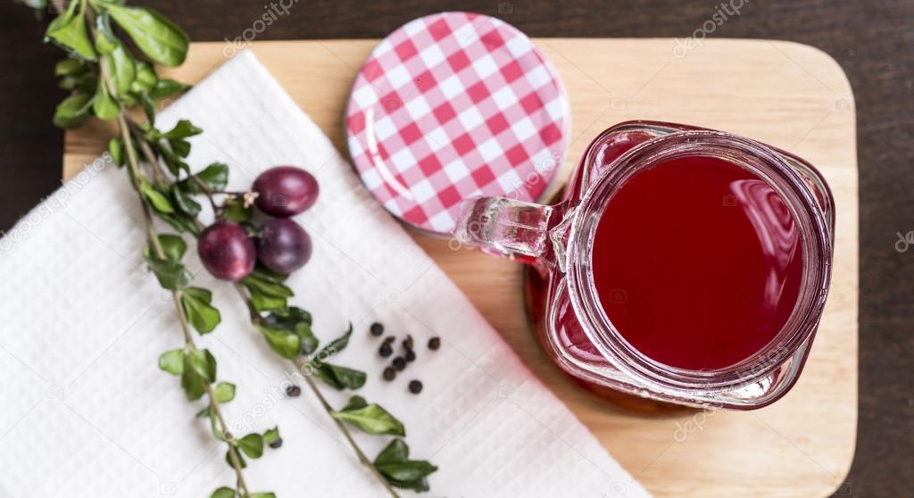 Berry juice in glass on chopping board flat lay