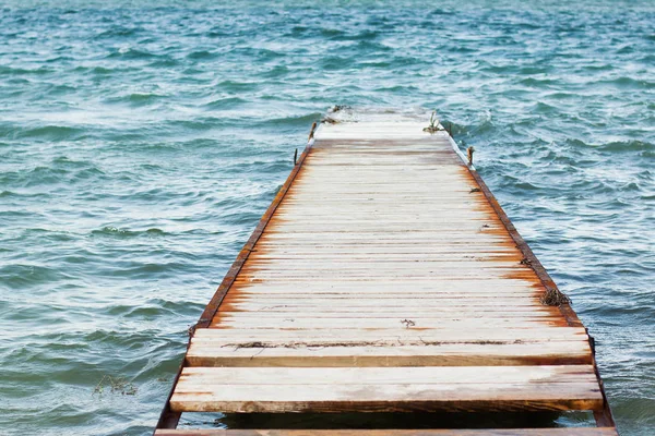 Old wooden pier and the calm sea
