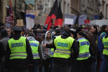 PRAGUE, CZECH REPUBLIC, FEBRUARY 6, 2016 Demonstration against Islam and immigrants, refugees in Prague, police oversees the demonstration, Central Bohemia, Europe, EU clipart