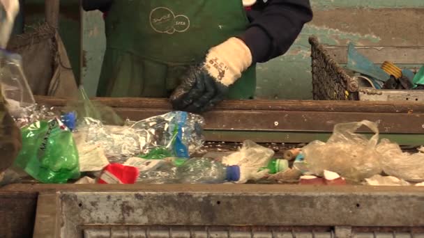 OLOMOUC, CZECH REPUBLIC, APRIL 25, 2018: Line conveyor belt for industrial sorting of different types of plastics waste, people. They are sorting on blue, green and transparent PET bottles, recycling — Stock Video
