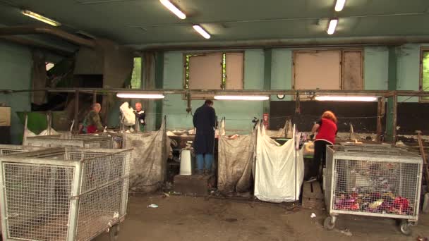 OLOMOUC, CZECH REPUBLIC, APRIL 25, 2018: Line for industrial sorting of different types of plastics waste. Poor and people job. They are sorting on blue, green and transparent PET bottles, recycling — Stock Video