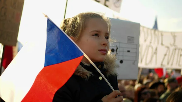 PRAGUE, CZECH REPUBLIC, NOVEMBER 16, 2019: Demonstration of people crowd against Andrej Babis demise, 300,000 mass protesters crowd throng of activists Letna Prague, flags young girl