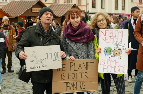 OLOMOUC, CZECH REPUBLIC, NOVEMBER 30, 2019: Activists senior old man and students, Friday for future, demonstration against climate change, banner sign the planet is hotter than us and money — ストック写真