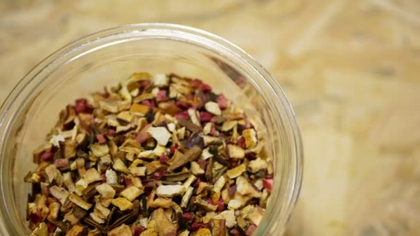 Herbal tea dried blend of rose glass jar cup, apple, lemon peel, cranberry, orange peel, star anise winter punch, cloves, cinnamon tea well decorative. Traditional folk medicine fruit, human health — Stock Video