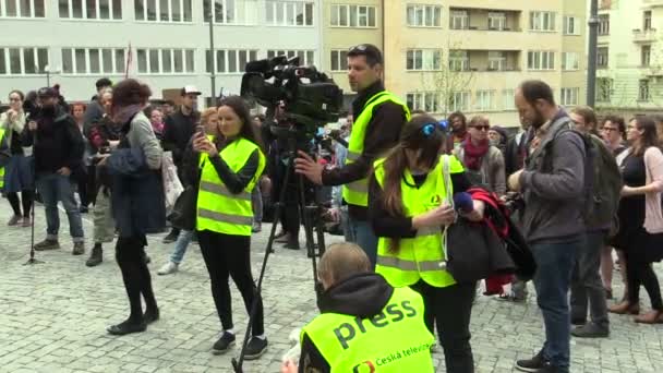 BRNO, CZECH REPUBLIC, MAY 1, 2019: People activists, reporter woman and cameraman filming a camera camcorder professional report television TV with a connected microphone, activism of young people — Stock Video