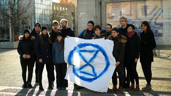 OLOMOUC, CZECH REPUBLIC, JANUARY 10, 2019: Extinction rebellion activist banner symbol circle hourglass is warning, men women people, demonstration activists activism rebels — Stockfoto