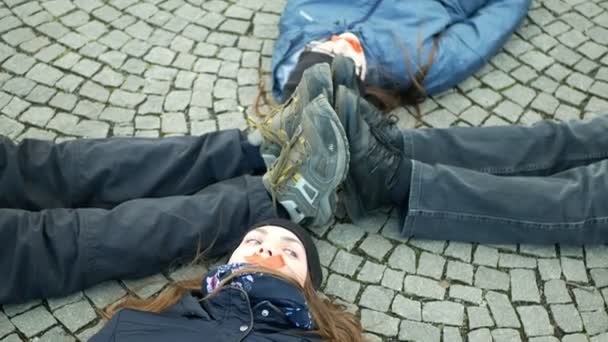 OLOMOUC, CZECH REPUBLIC, JANUARY 10, 2019: Extinction rebellion activists protest protesting against climate change warning, women people lie on ground square showing death, demonstration — Wideo stockowe