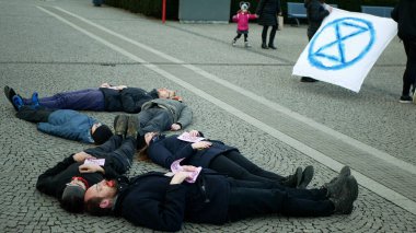 OLOMOUC, CZECH REPUBLIC, JANUARY 10, 2019: Extinction rebellion activist banner symbol circle hourglass is warning, men women people, demonstration activists activism rebels