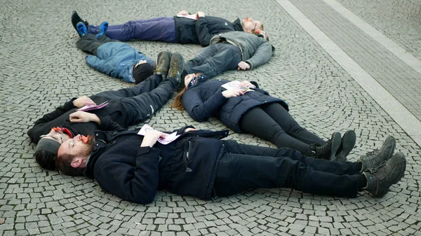 OLOMOUC, CZECH REPUBLIC, JANUARY 10, 2019: Extinction rebellion activists protest protesting against climate change warning, men people lie on ground square showing death, demonstration — Stok fotoğraf