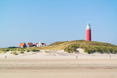 Beach and lighthouse De Cocksdorp, Texel, Netherlands clipart