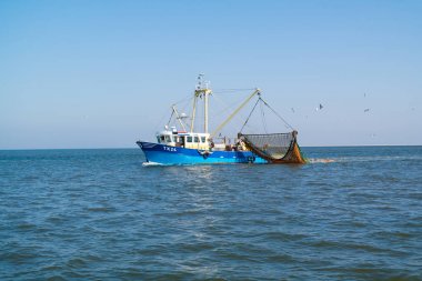 Fishing boat or shrimp trawler fishing on Waddensea, Netherlands clipart