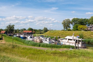 Rampart and boats in fortified town of Wouddrichem, Netherlands clipart
