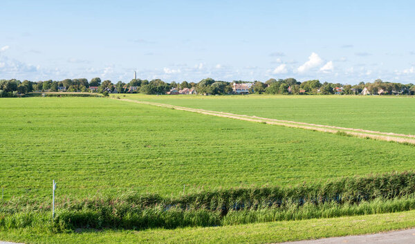 Fields in polder and water tower on Frisian island Schiermonniko