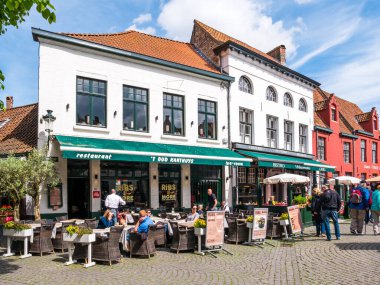People and outdoor terrace of restaurant on Wijngaardplein in Bruges, Belgium