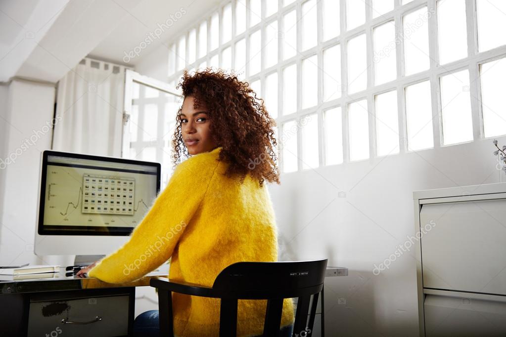 black woman working with graphs on workplace 