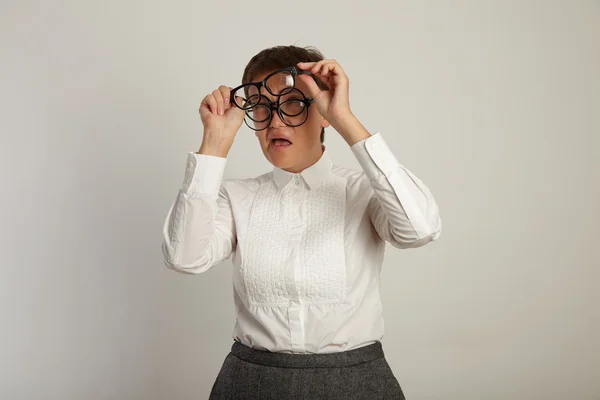 Teacher trying to put on three pairs of glasses — Stock fotografie