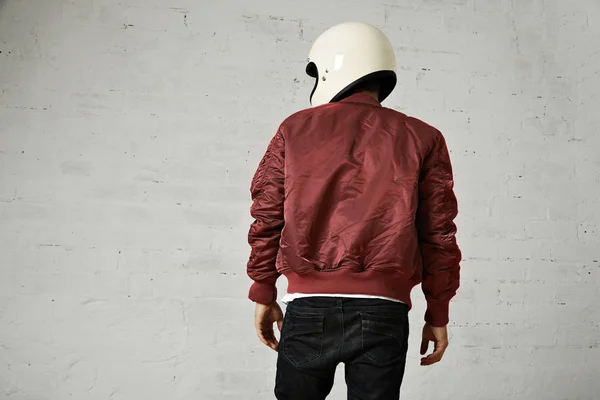 Man in a bordeaux pilot jacket with helmet — Stock Photo, Image