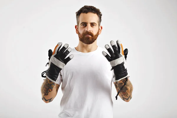 Young attractive man demonstrating snowboard gloves