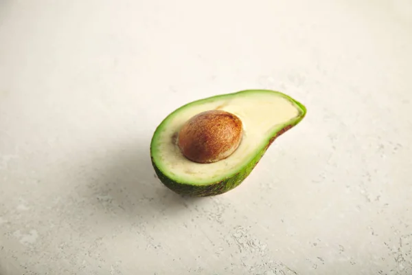 Avocado cut in half on white — Stock Photo, Image