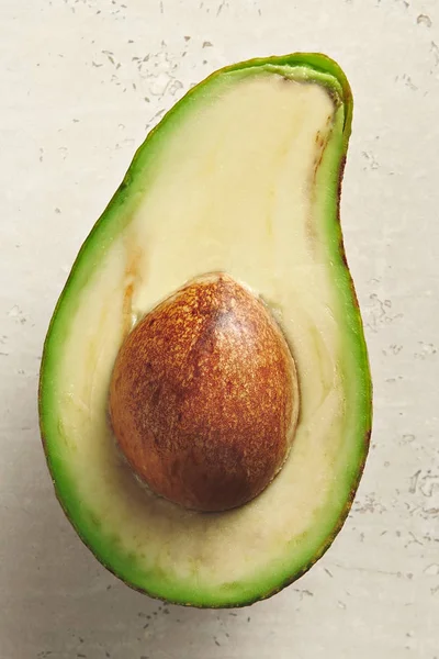 Avocado cut in half on white — Stock Photo, Image