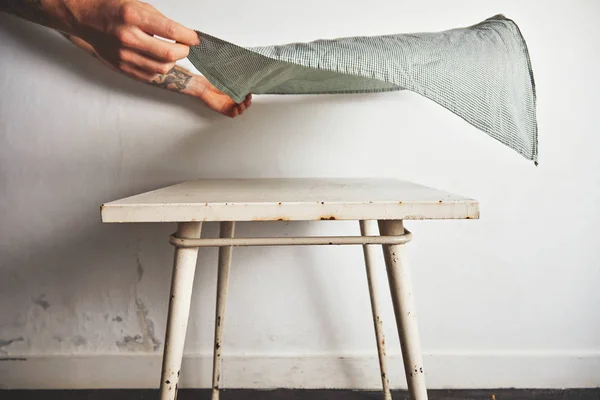 Putting tablecloth on old white table — Stock Photo, Image