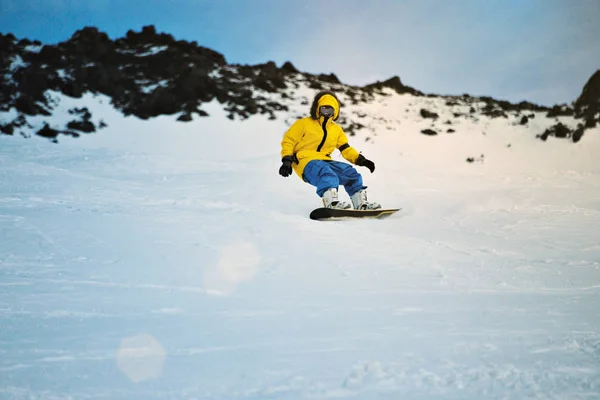 Snowboard w zachód słońca w górach — Zdjęcie stockowe