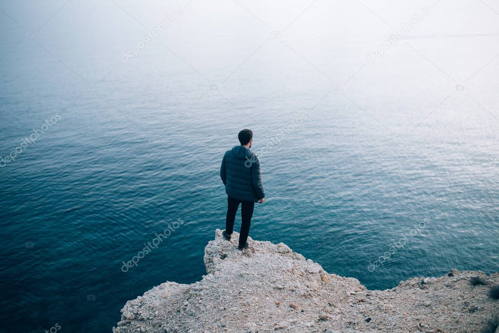 Lonely man stares at the sea