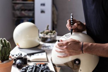Close up designer customizing retro helmet clipart