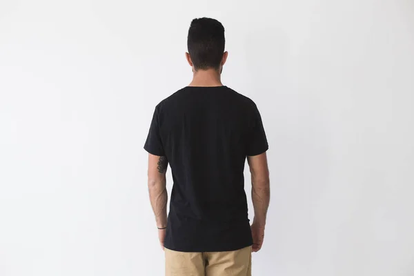 Uomo attraente posa in nero semplice t-shirt — Foto Stock