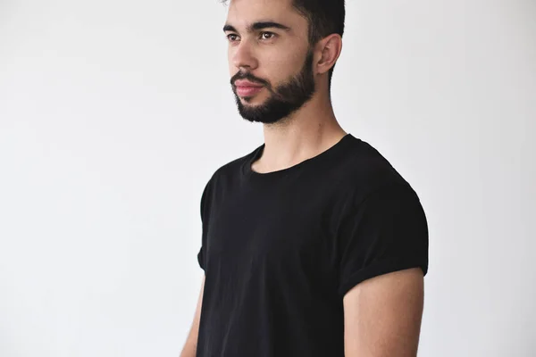 Attractive man poses in black simple tshirt — Stock Photo, Image