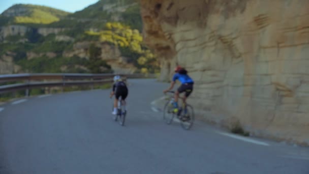 Två cyklister rida tillsammans i bergen — Stockvideo