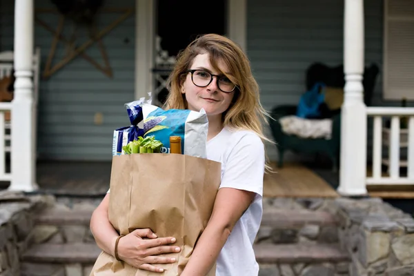 Girl with big paper grocery bag Royalty Free Stock Images