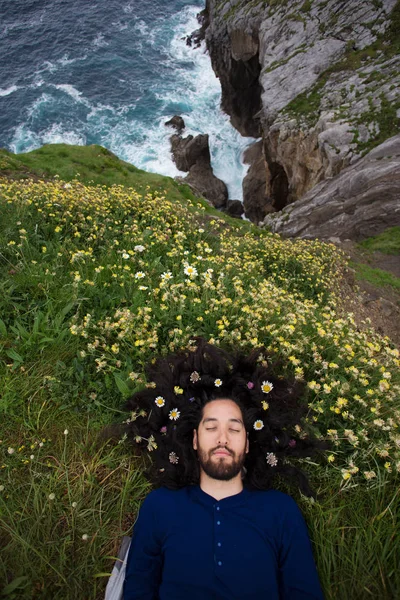bearded man with flowers in hair