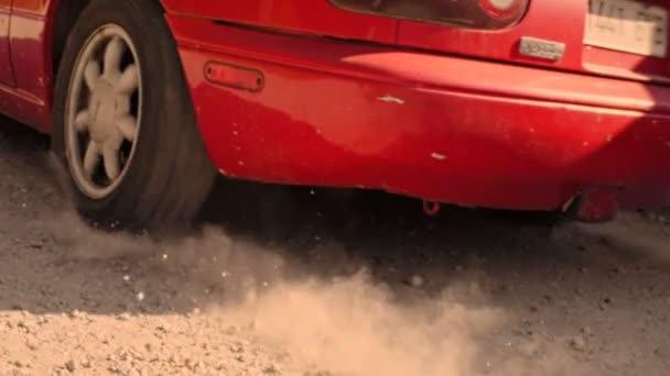 Neumáticos de cámara lenta en la grava del coche de carreras — Vídeo de stock