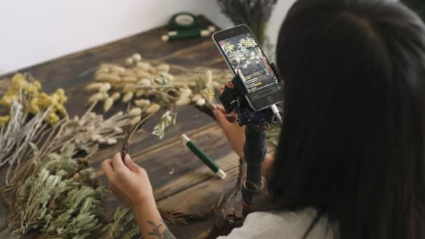 Static shot of crafts woman filming her work process — Stock Video