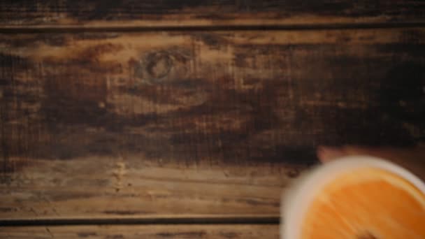 Top view of hand with glass and orange slice inside — Stock Video